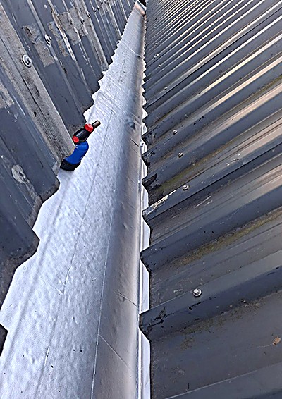 Membrane-lined box gutter valley on a corrugated metal roof
