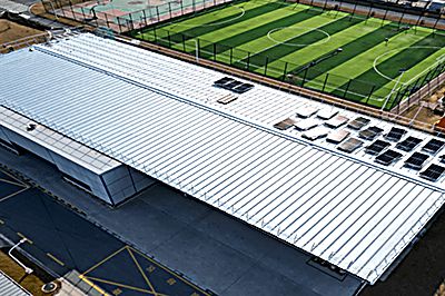 Large standing-seam metal roof refinished with a reflective membrane