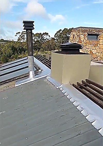 Ridge and flashing detail sealed around roof penetrations